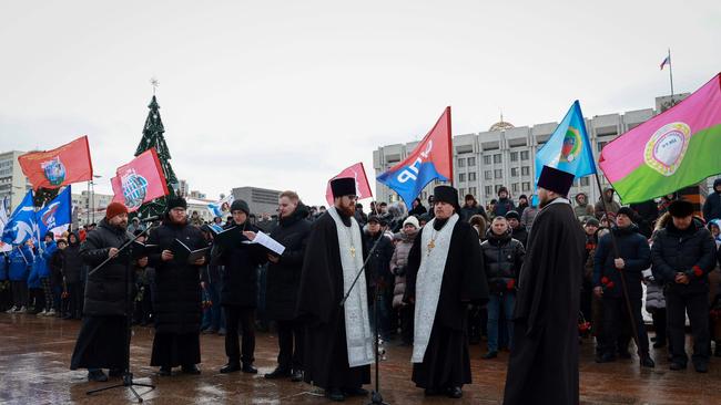 Mourners gather with priests to lay flowers in memory of more than 60 Russian soldiers that Russia says were killed in a Ukrainian strike in Samara on January 3. Picture: Arden Arkman / AFP