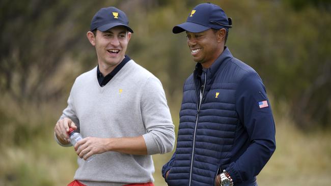 Tiger Woods (right) chats with Patrick Cantlay on day three at Royal Melbourne. Picture: AP