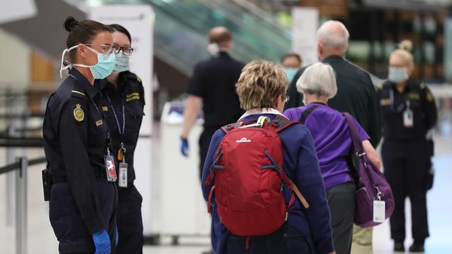 Australian Border Force officers talk with New Zealand passengers from the Vasco Da Gama cruise ship in Perth last week. Picture: Paul Kane/Getty Images