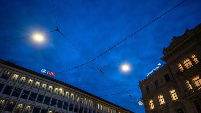 This photograph taken in Zurich on March 20, 2023, shows the headquarters of the Credit Suisse bank (R) next to an office of Swiss giant bank UBS. UBS agreed to take over Credit Suisse for $3 billion Swiss francs in a government-brokered deal on March 19, 2023 following days of market upheaval over the health of the banking sector. (Photo by Fabrice COFFRINI / AFP)