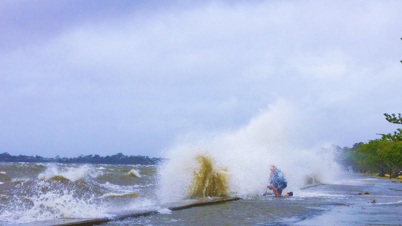 A local legend braves the waves to unclog drainage pipes, hoping to save nearby homes from flooding. PHOTO CREDIT: Dianna Jean Photography.