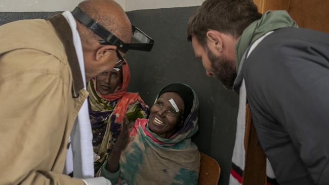 Dr Wondu Alemayehu and Joel Edgerton meet Hawiti before her surgery. Picture: Michael Amendolia/Fred Hollows Foundation