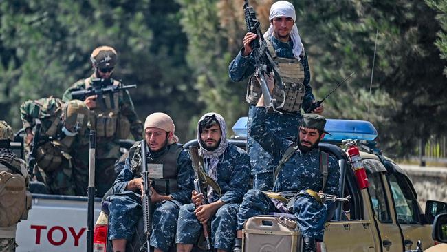 Taliban fighters patrol along a street in Kabu. Picture: AFP