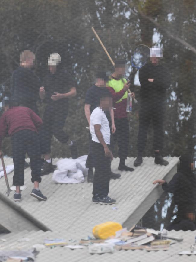 Detainees on the roof of the Frank Baxter Juvenile Justice Centre where several inmates were stabbed during a riot. Picture: AAP