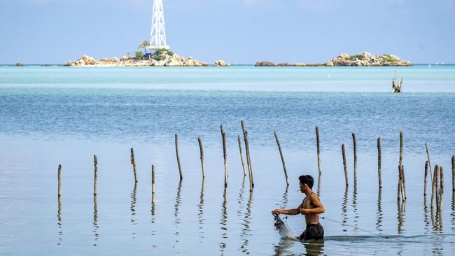 An Indonesian fisherman sets net at Pulau Laut. Picture: Jiro Ose