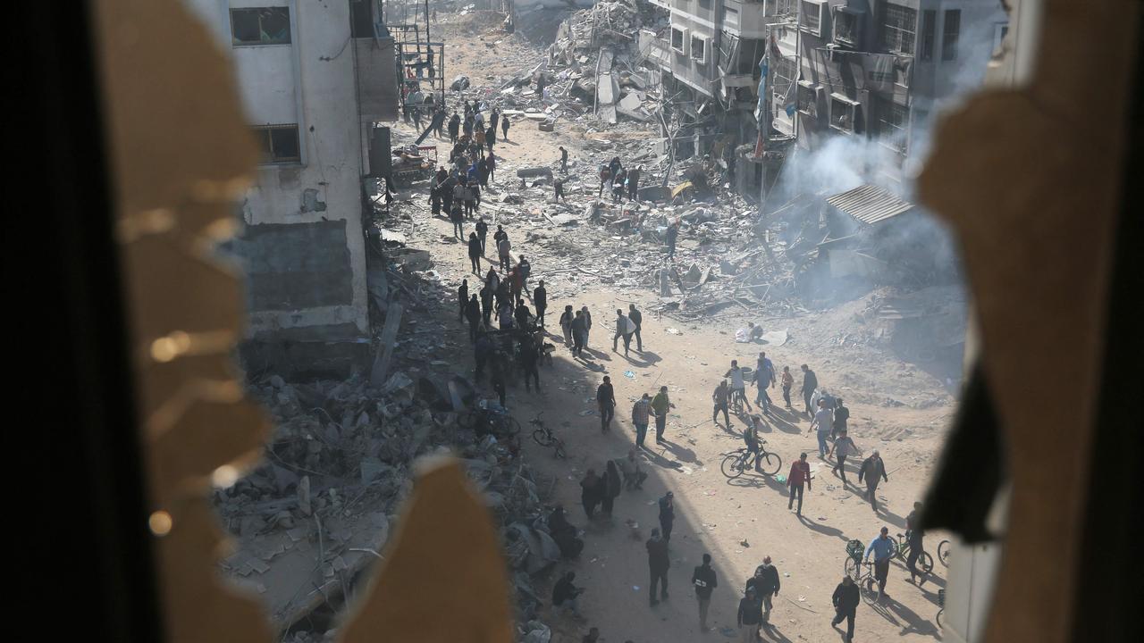 Palestinians inspect the damage in the area around Gaza's Al-Shifa hospital after the Israeli military withdrew. Picture: AFP