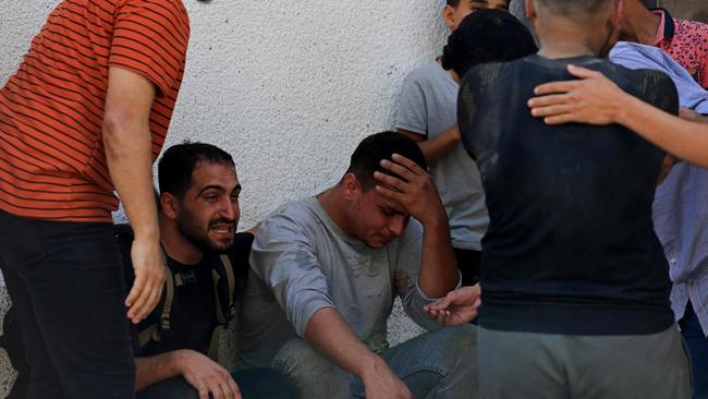 People mourn the death of Palestinians who were killed in the latest infiltration operation into Israel, outside al-Shifa hospital in Gaza City on October 7.