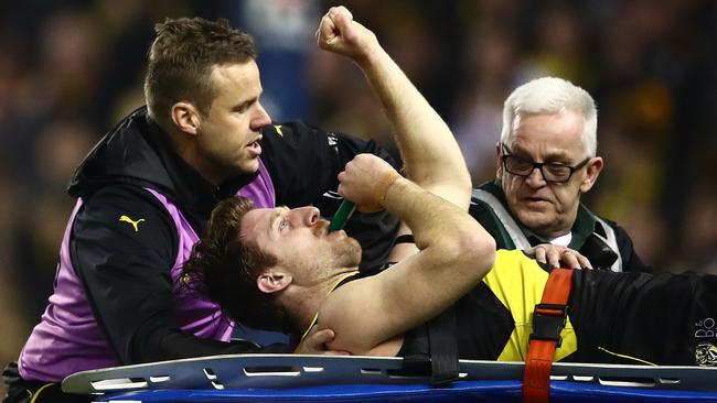 Reece Conca salutes the crowd as he’s stretchered off.