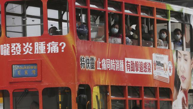 Passengers on a Hong Kong tram wear face masks in hopes to prevent contracting the spreading coronavirus.