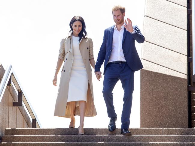 Harry and Meghan hold hands during a walk and meet at The Sydney Opera House. Picture: Justin Lloyd