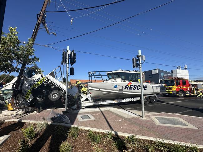 A truck from the SA Sea Rescue Squadron has crashed on Brighton road, with a rescue boat attached to the back.