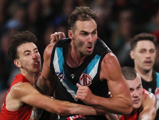 ADELAIDE, AUSTRALIA – APRIL 05: Nic Martin of the Bombers tackles Jeremy Finlayson of the Power during the 2024 AFL Round 04 match between the Port Adelaide Power and the Essendon Bombers at Adelaide Oval on April 05, 2024 in Adelaide, Australia. (Photo by James Elsby/AFL Photos via Getty Images)