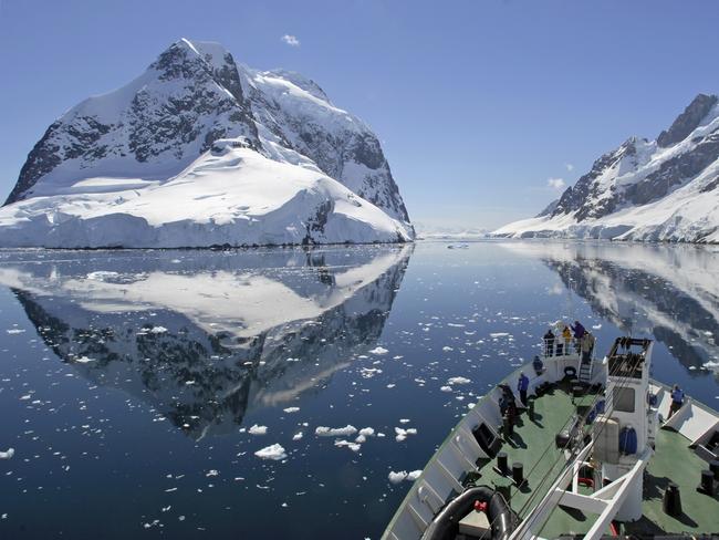 A small cruise ship makes passage through the Lemaire Channel in Antarctica. Picture: iStock