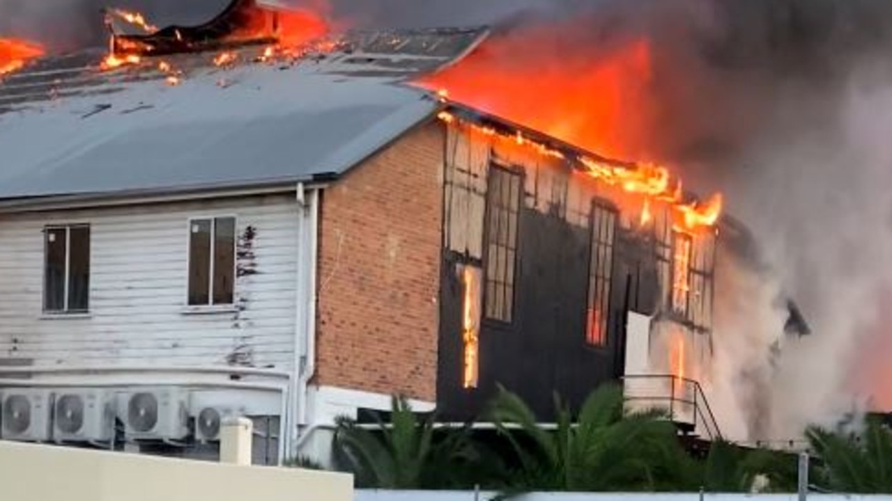 A building burns following a huge industrial fire at Woolloongabba on Wednesday.