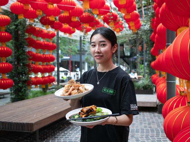 Waitress Anna Sayyavong (30) from CBD holding food from Lilong restaurant amongst the New Year Lanterns in Chinatown. Picture: Julian Andrews