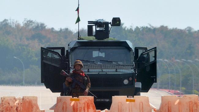 A soldier stands guard on a blockaded road to Myanmar's parliament in Naypyidaw on February 1. Picture: AFP.