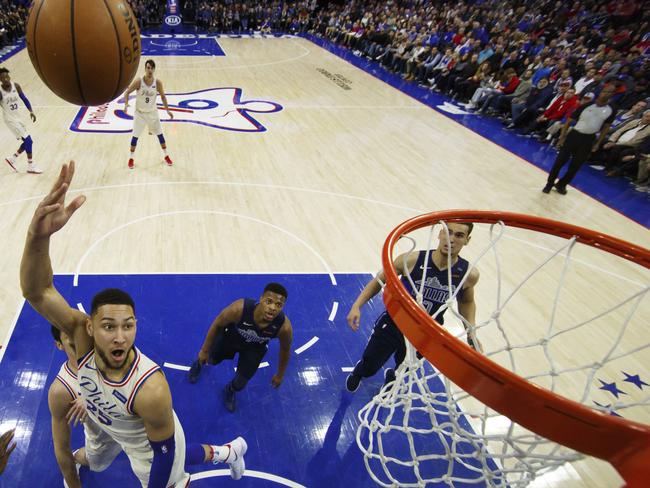 Philadelphia 76ers' Ben Simmons, left, of Australia, shoots during the second half of an NBA basketball game against the Dallas Mavericks, Sunday, April 8, 2018, in Philadelphia. The 76ers won 109-97. (AP Photo/Chris Szagola)