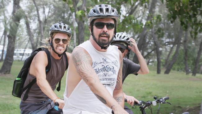 Foo Fighters frontman Dave Grohl (right) and drummer Taylor Hawkins and some mates ride around the Gold Coast ahead of their Australian show in Brisbane in 2015. Picture: Tim Marsden