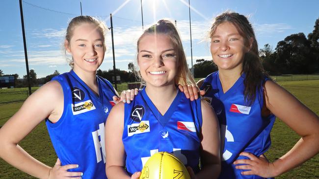 Michaela Young, Zoe Mitchell and Laura Beattie, playing for Hastings, are three of the many looking to get in on suburban footy this year. Picture: Alex Coppel