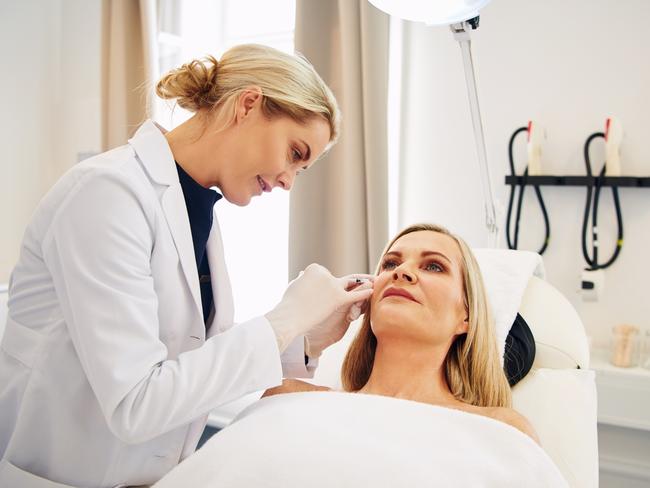 SMARTdaily zoom facialsYoung female doctor doing botox injections on the face of a mature woman lying on a table in a beauty clinic