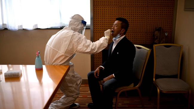 A journalist undergoes a swab test for the COVID-19 coronaviru in Beijing. Picture: AFP