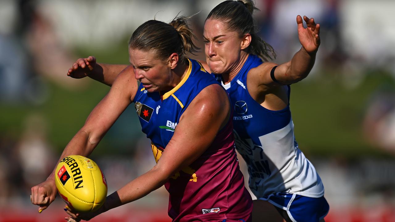 BRISBANE, AUSTRALIA - SEPTEMBER 01: Kate Lutkins of the Lions handballs under pressure during the round one AFLW match between Brisbane Lions and North Melbourne Kangaroos at Brighton Homes Arena, on September 01, 2024, in Brisbane, Australia. (Photo by Albert Perez/AFL Photos/via Getty Images)