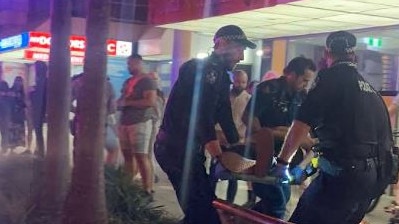 A man is stretchered into an ambulance in the aftermath of a brawl involving two patrons and Cali Beach Club security outside the venue on Surfers Paradise Boulevard. The man was transported to Gold Coast University Hospital and is said to be in a stable condition.