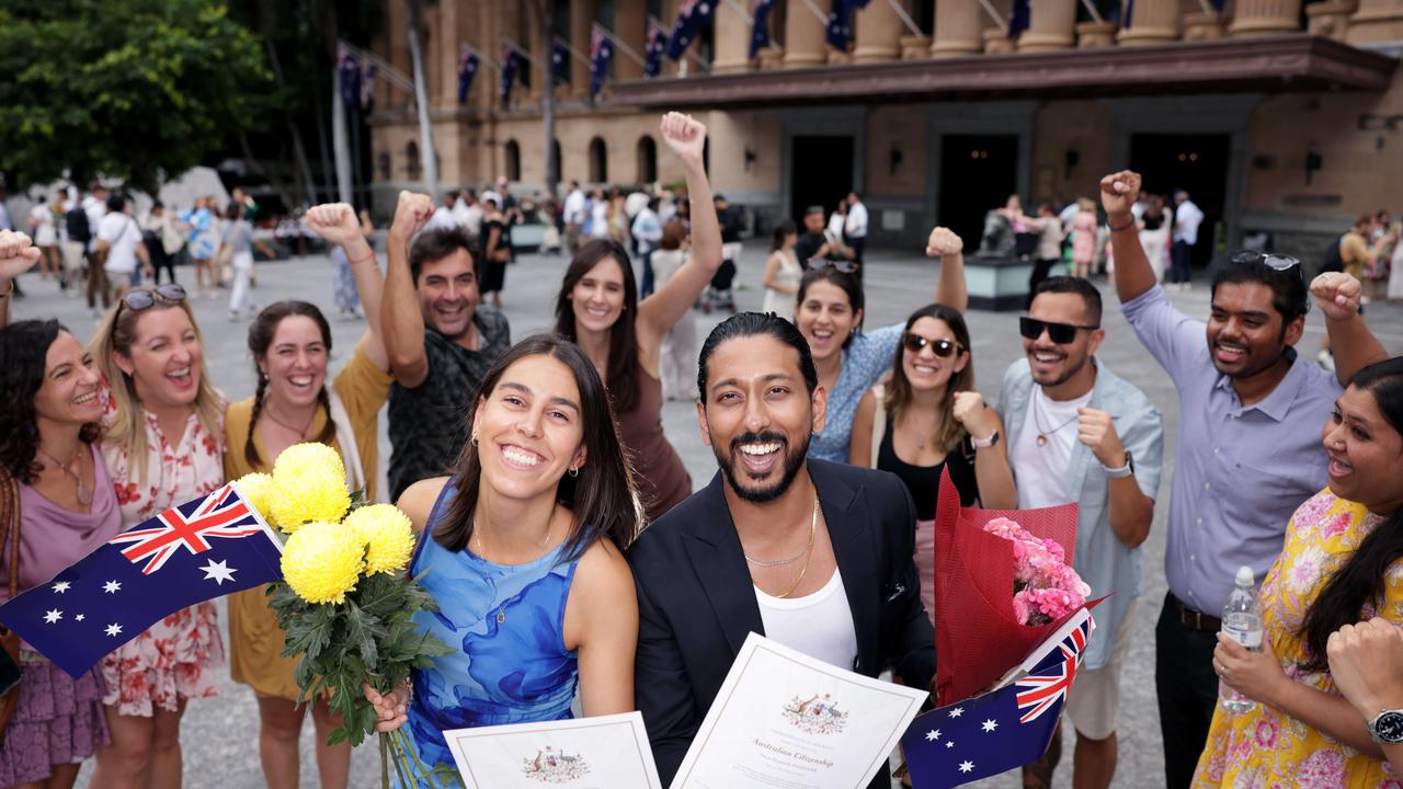 Mariona Duran Casas with Prem Panicker and friends behind, as Brisbane to welcomes 500 new citizens on Australia Day at City Hall. Photo Steve Pohlner