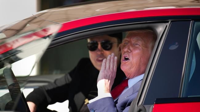 US President Donald Trump with his “adviser” Elon Musk sit in a Tesla outside the White House this week. Picture: Getty Images