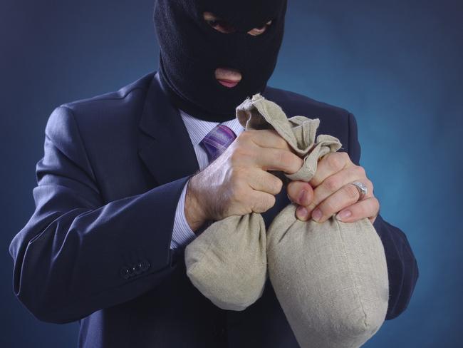 Man with a mask and bags of money. Bank robber. Heist. Robbery. Business. Generic image.