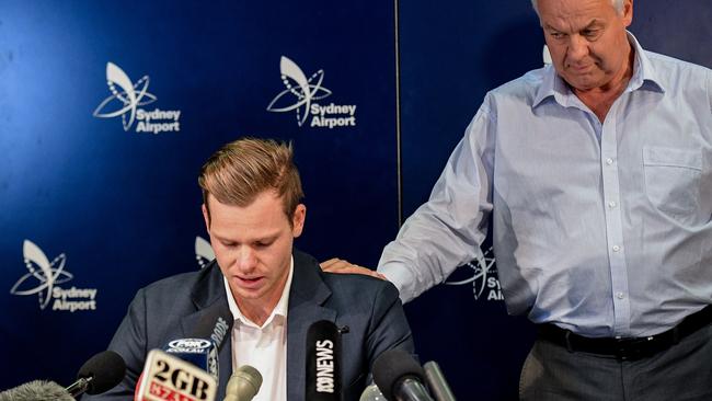 Disgraced Australian cricket captain Steve Smith is comforted by his father Peter at the press conference at Sydney Airport on Thursday night.