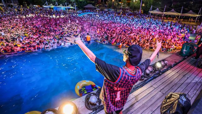 A rapper entertains the crowd at the massive pool party. One resident told Chinese state media that the party was “payback” for the country’s efforts to suppress the virus. Picture: AFP