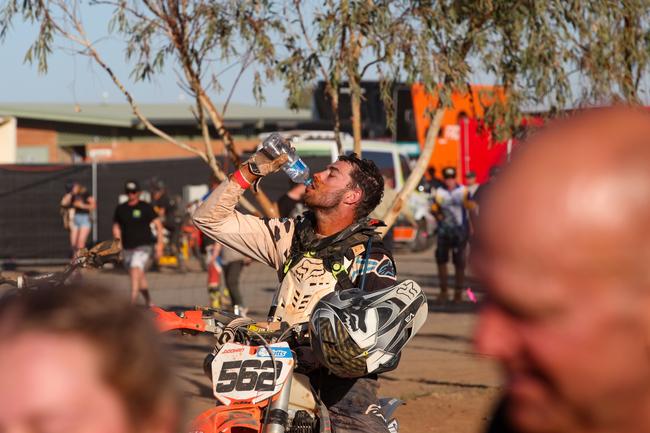 Joel Doohan immediately rehydrates after pushing himself to the limit during the 2019 Tatts Finke Desert Race. Pic: MATT HENDERSON