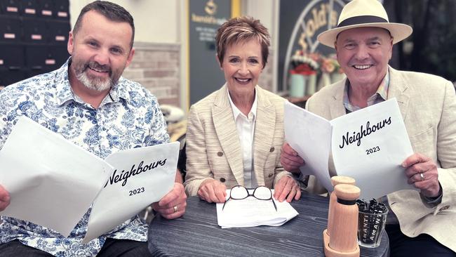 Ryan Moloney, Jackie Woodburne and Alan Fletcher with Neighbours scripts for 2023. Picture: Supplied