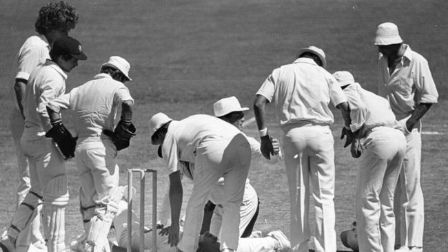 Australian Rick Darling lays on the ground after being hit by a ball from Bob Willis (L). Picture: Bryan Charlton