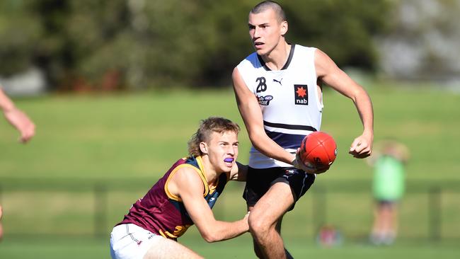 Joel Fitzgerald looks to get a handball away under pressure. Picture: Steve Tanner