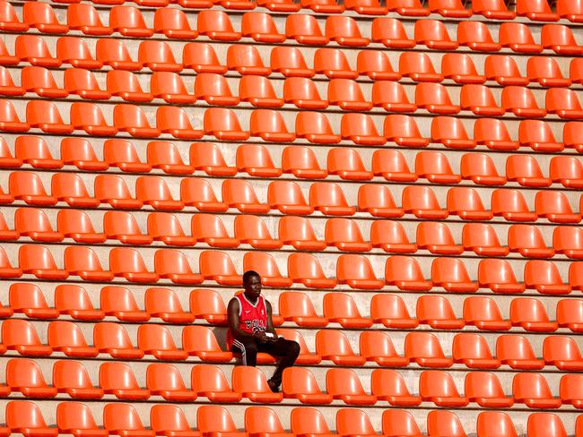 A fan eagerly awaits the Africa Cup of Nations 2024 round of 16 clash between Angola and Namibia. Picture: Kenzo Tribouillard/AFP