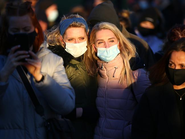 People gather to pay their respects at a vigil on Clapham Common, where floral tributes have been placed for Sarah Everard. Picture: Hollie Adams/Getty Images