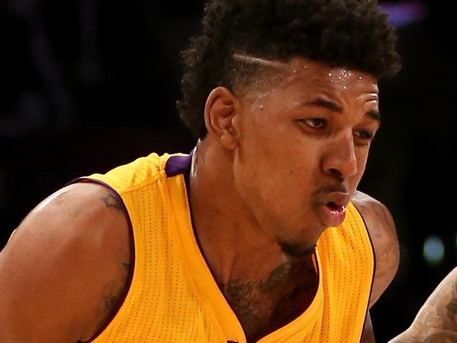 LOS ANGELES, CA - FEBRUARY 10: Nick Young #0 of the Los Angeles Lakers drives past Wilsn Chandler #21 of the Denver Nuggets at Staples Center on February 10, 2015 in Los Angeles, California. NOTE TO USER: User expressly acknowledges and agrees that, by downloading and or using this photograph, User is consenting to the terms and conditions of the Getty Images License Agreement. Stephen Dunn/Getty Images/AFP == FOR NEWSPAPERS, INTERNET, TELCOS & TELEVISION USE ONLY ==