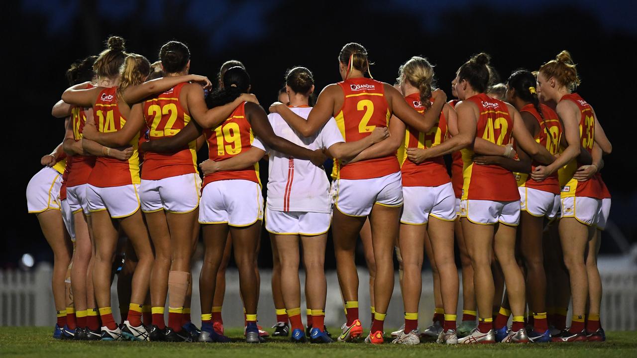 BRISBANE, AUSTRALIA - DECEMBER 17: The Gold Coast Suns huddle during the AFLW practice match between the Gold Coast Suns and the Brisbane Lions at Yeronga South Brisbane Football Club on December 17, 2021 in Brisbane, Australia. (Photo by Albert Perez/AFL Photos via Getty Images)