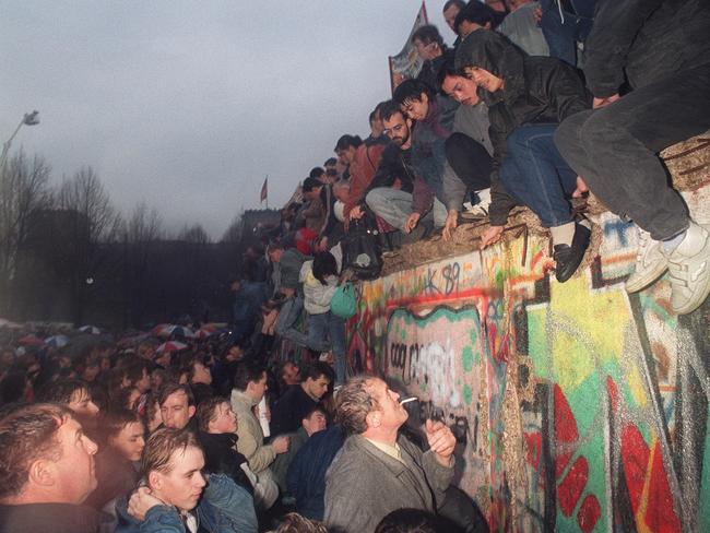 People from East Germany greet citizens of West Germany at the Brandenburg Gate in Berlin, 22 December 1989. The significance of the fall of the Berlin Wall gave the 1990s an undeniable air of optimism.