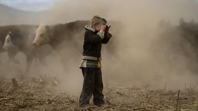 Harry plays on the dust bowl his family farm has become during the drought. Picture: Getty