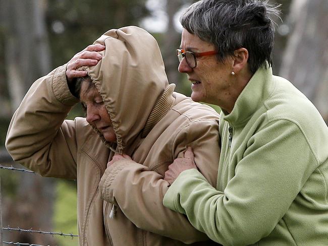 Ray Fox’s devastated wife is supported by a neighbour after the tragedy. Picture: Simon Cross