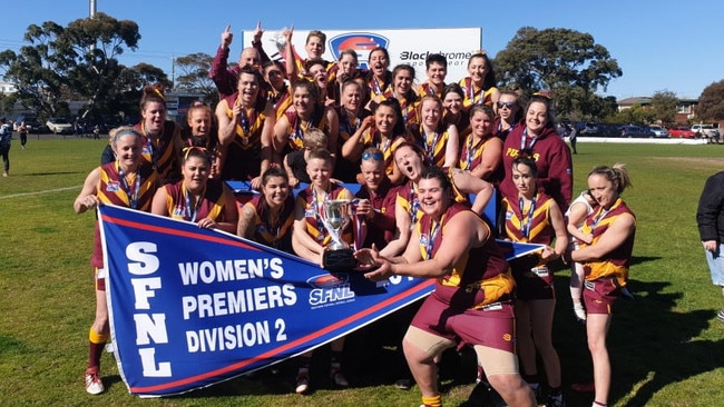 The Lyndale women's team shows off its premiership pennant.