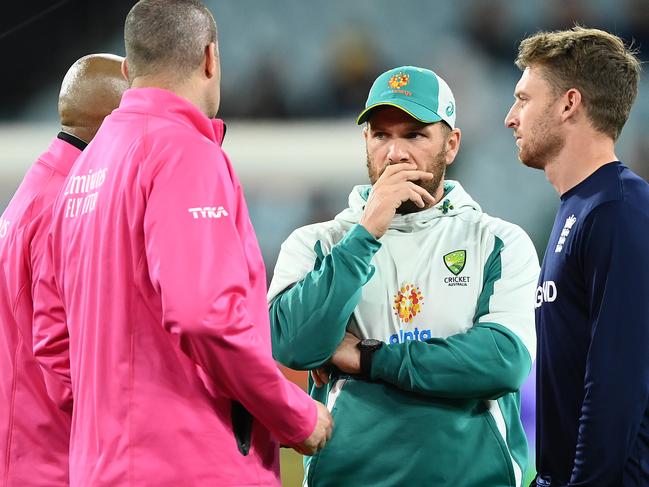 MELBOURNE, AUSTRALIA - OCTOBER 28:  Jos Buttler of England and Aaron Finch of Australia speak with the umpires as rain delays play during the ICC Men's T20 World Cup match between England and Australia at Melbourne Cricket Ground on October 28, 2022 in Melbourne, Australia. (Photo by Quinn Rooney/Getty Images)