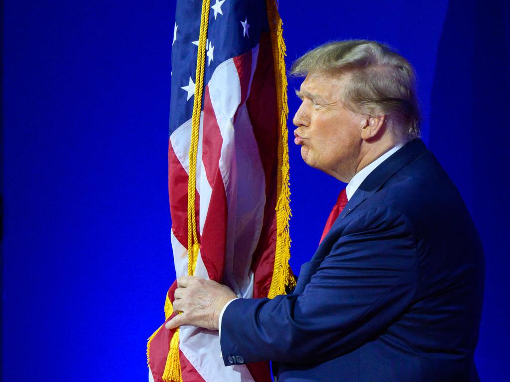 Former US president Donald Trump kisses the US flag as he arrives to speak during the annual Conservative Political Action Conference in National Harbor, Maryland. Picture: AFP