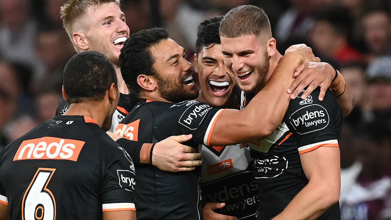 Adam Doueihi of the Tigers celebrates with teammates after scoring a try.