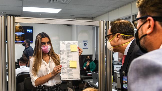 lectoral workers inspect a ballot during the vote-by-mail ballot scanning process at the Miami-Dade County Election Department in Miami, Florida. Picture: AFP