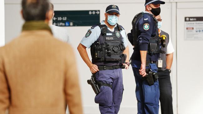 Police officers enforce mandatory mask etiquette at Central Station. Picture: Sam Ruttyn