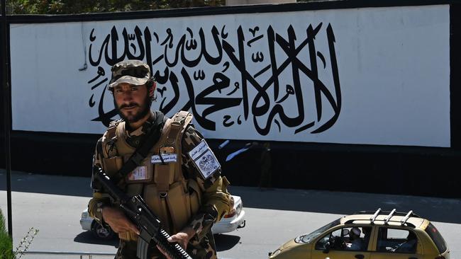 Embassies across Kabul have been taken over by Taliban. Here a member of the Taliban Fateh fighter, a "special forces" unit, stands guard outside the US Embassy in Afghanistan displaying a Taliban flag in the outer concrete wall in Kabul on September 8, 2021. Picture: Aamir QURESHI / AFP